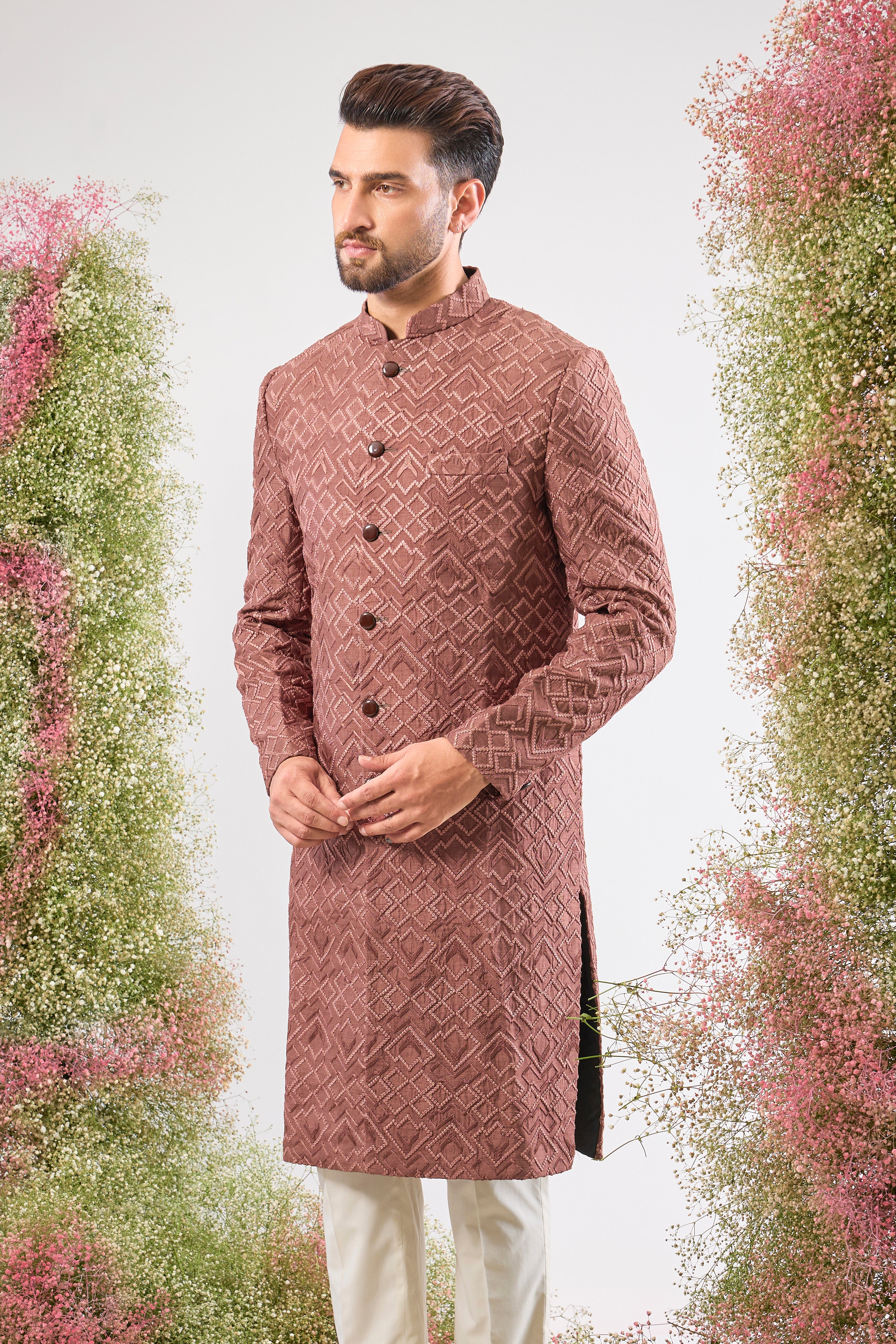 This Mauve Taupe Sherwani is a masterpiece of design, showcasing intense Heavy Thread Work in a mesmerizing Geometrical Pattern across the luxurious silk fabric.