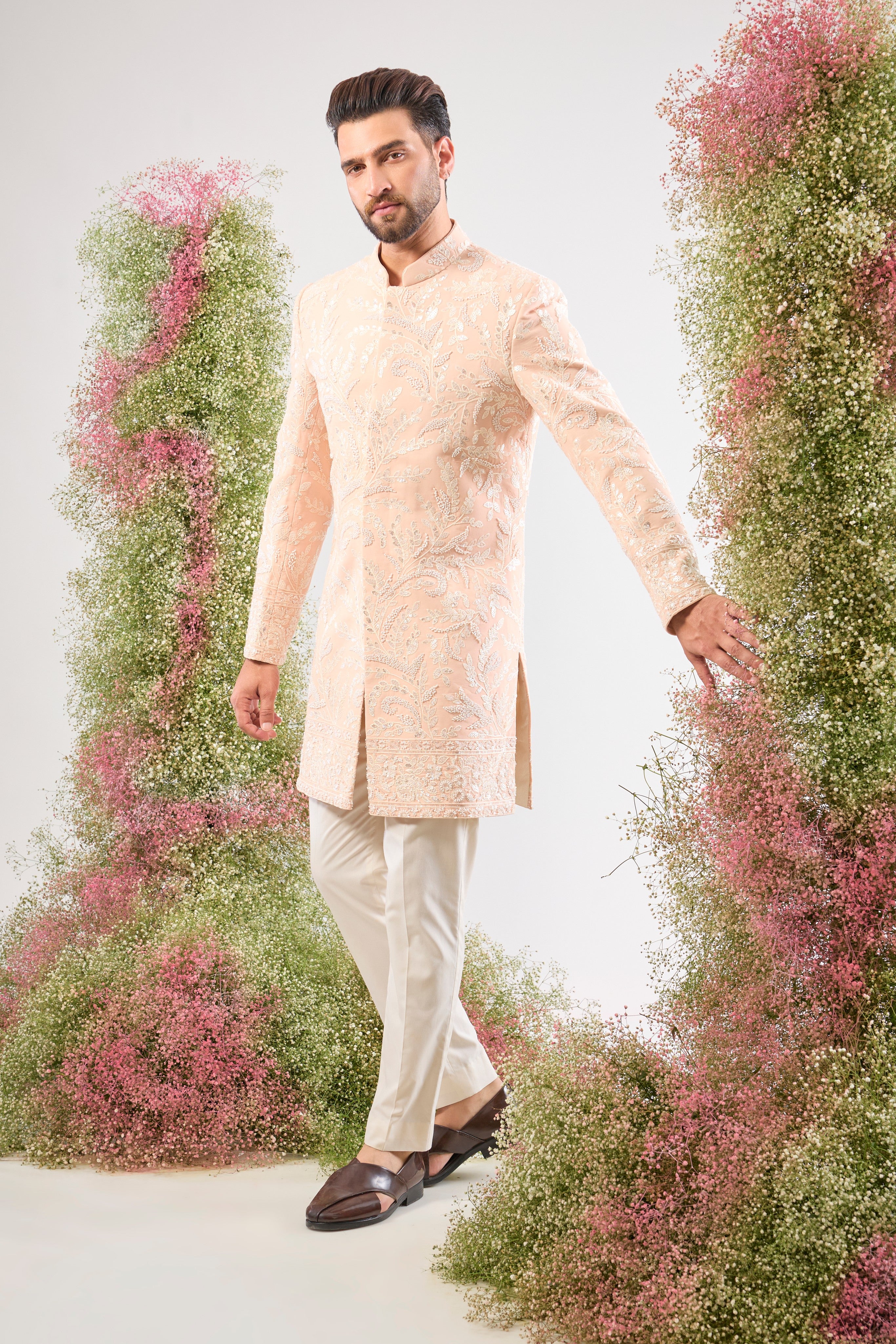 This short Sherwani showcases the impressive weight and brilliance of Heavy Cut Dana in White, perfectly complemented by detailed Floral Embroidery.