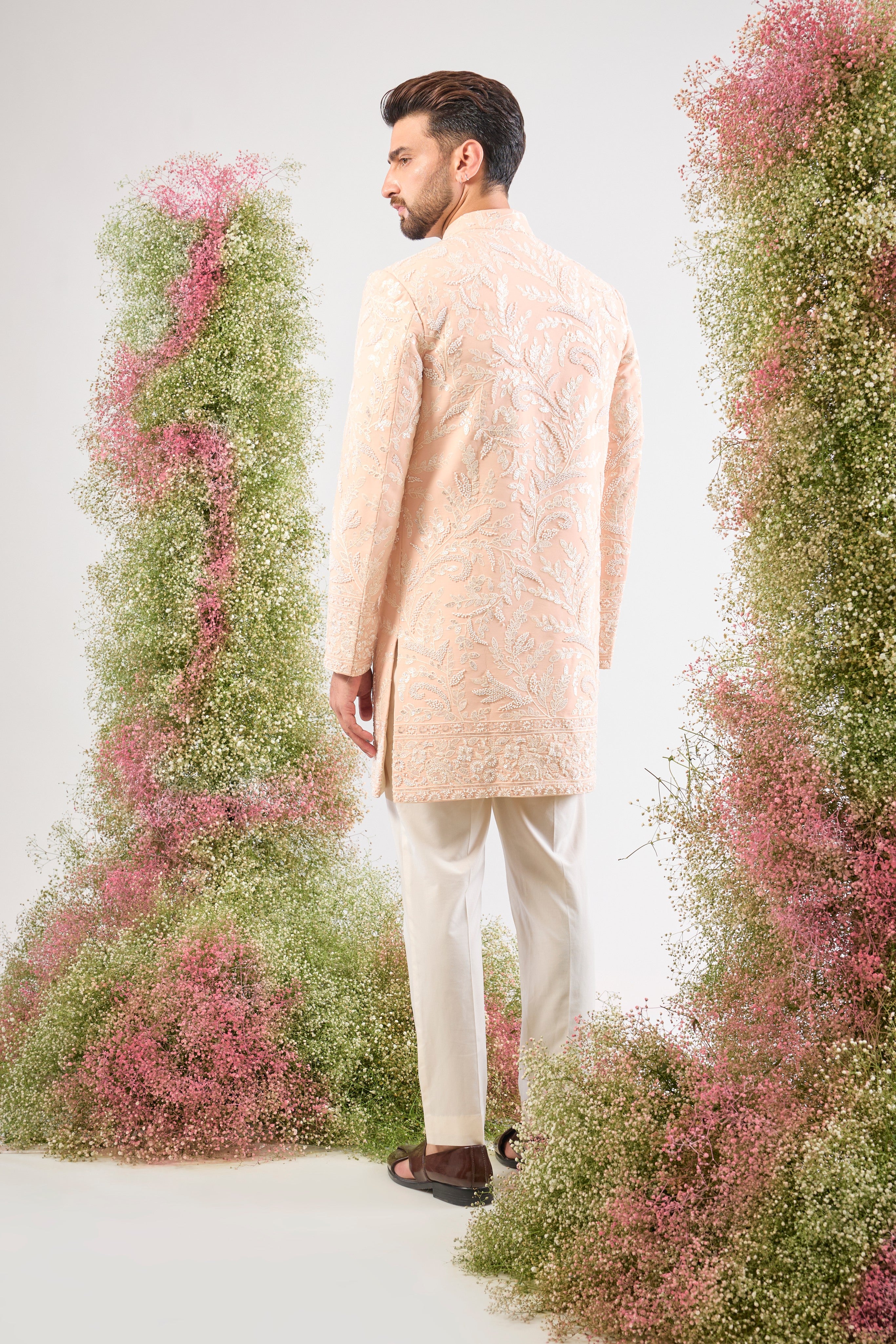 This short Sherwani showcases the impressive weight and brilliance of Heavy Cut Dana in White, perfectly complemented by detailed Floral Embroidery.