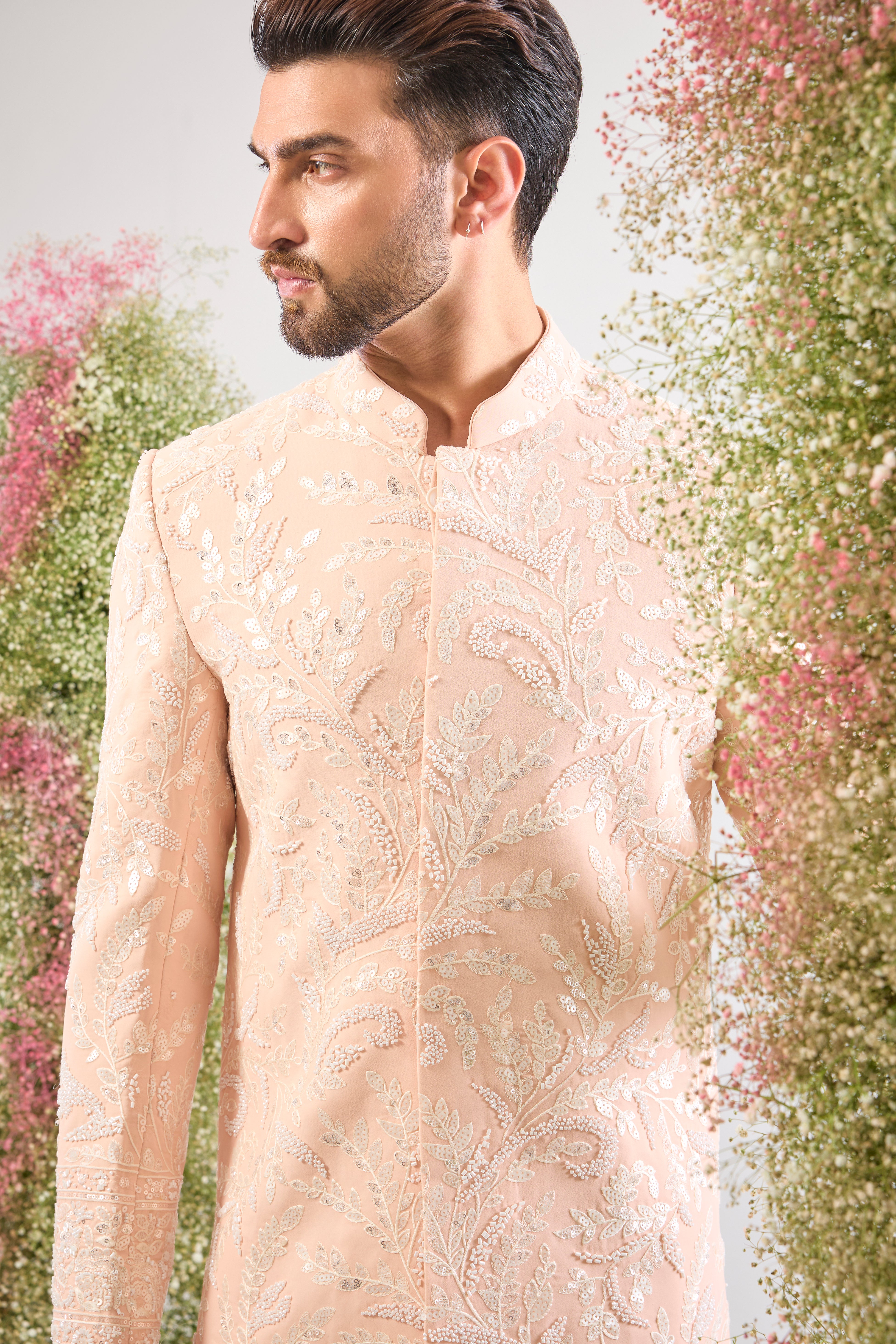 This short Sherwani showcases the impressive weight and brilliance of Heavy Cut Dana in White, perfectly complemented by detailed Floral Embroidery.
