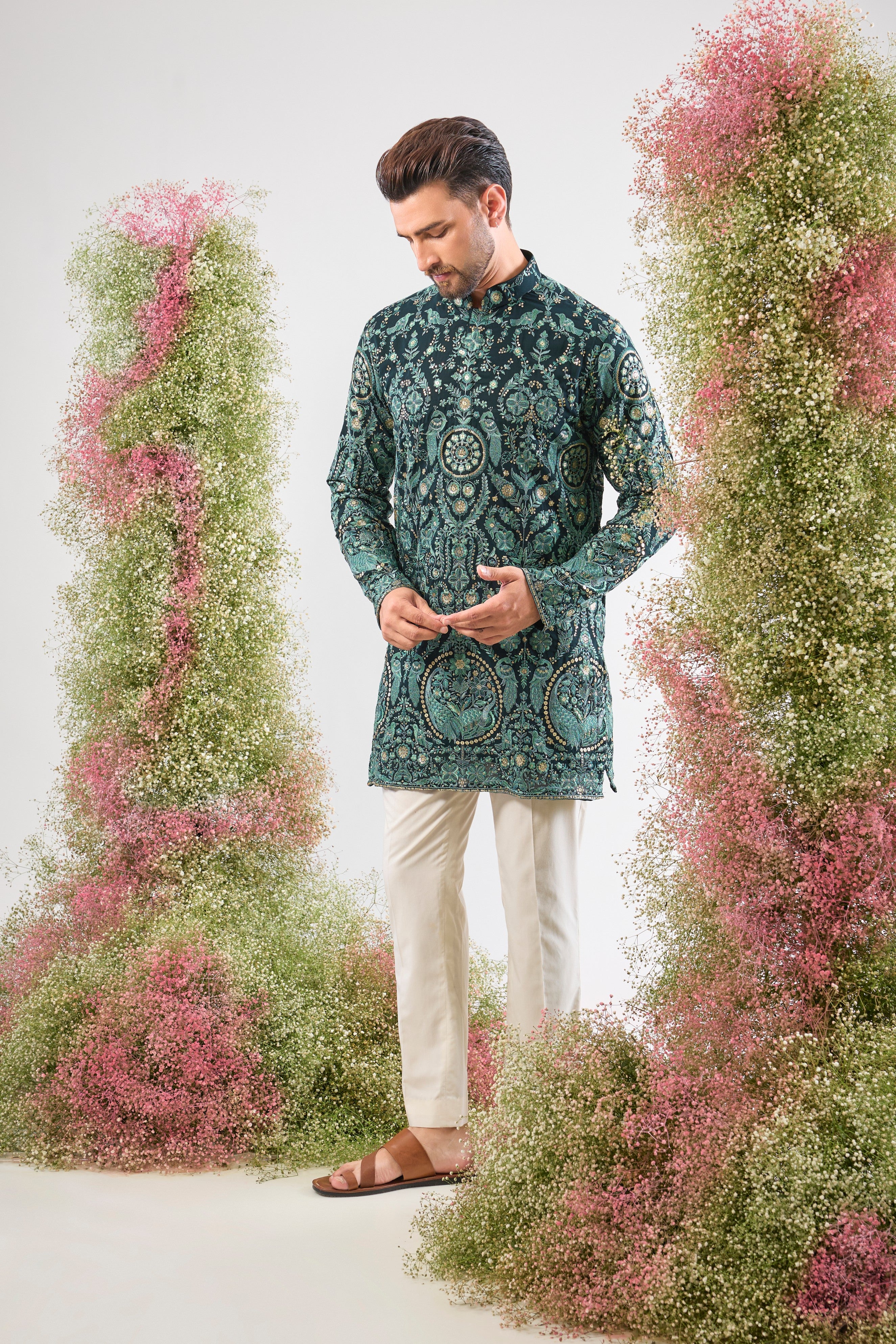 This Short Thread Work Kurta is lavishly detailed with intricate craftsmanship, featuring Detailed Flora and Fauna Embroidery and brilliant Detailed Sequins. The rich colour and complex texture create an opulent look designed to stand out.