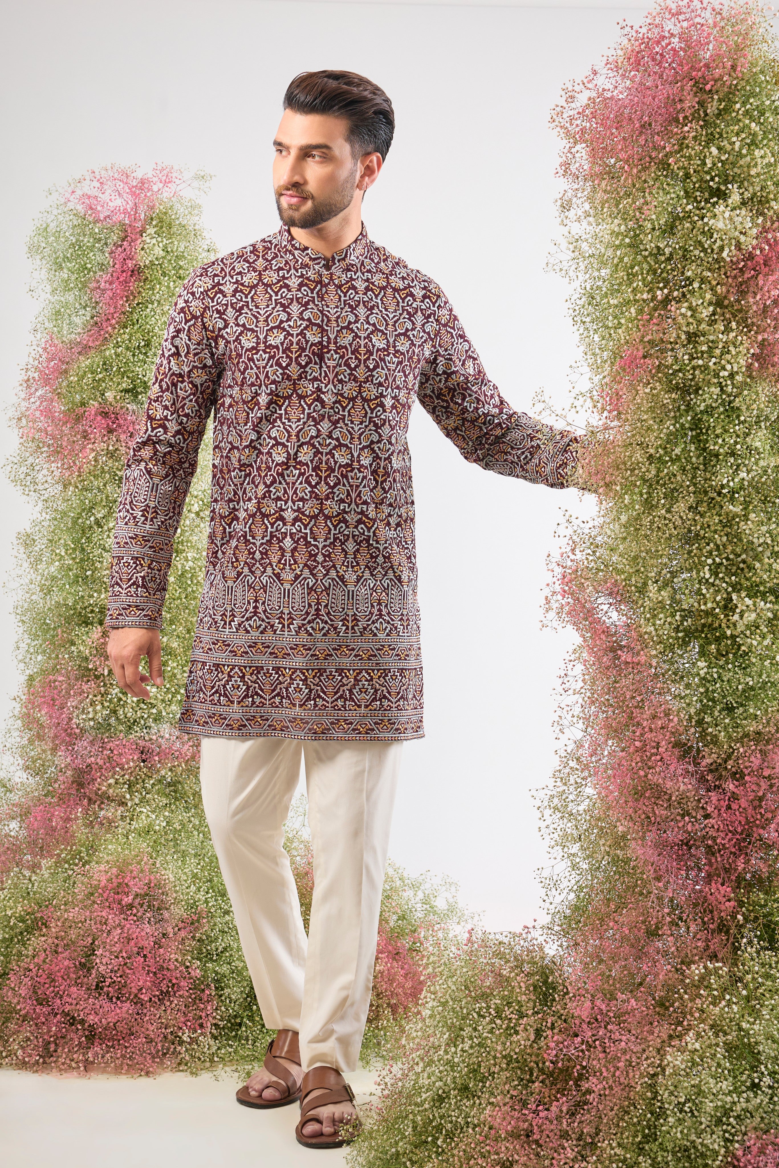 his Maroon Short Kurta showcases exquisite Intricate Multi-thread Work in a traditional pattern, beautifully highlighted by shimmering Sequin Details.