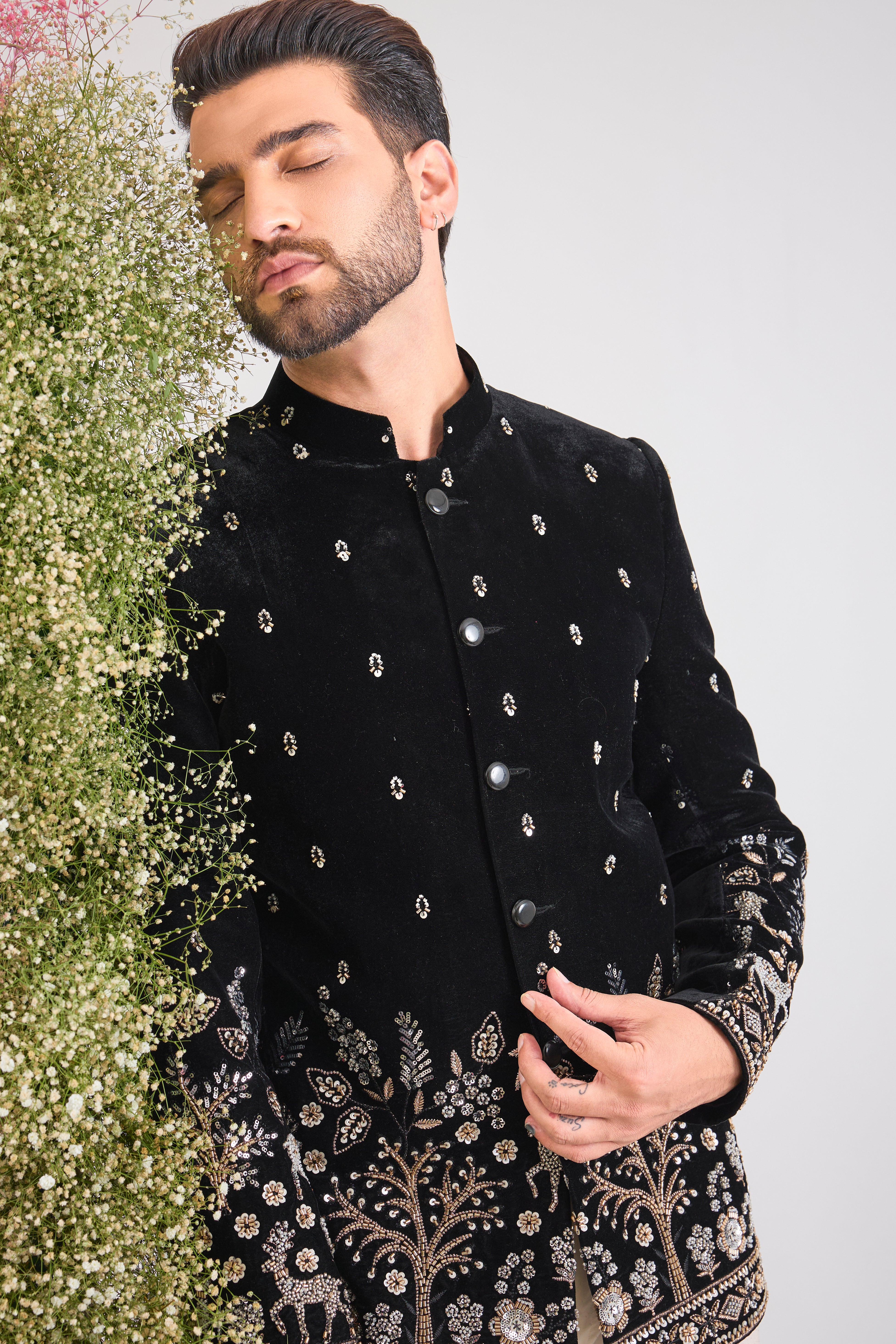 This Black Bandhgala showcases extraordinary, concentrated Handwork featuring shimmering Sequins, textural Beads, and reflective Cut Dana.