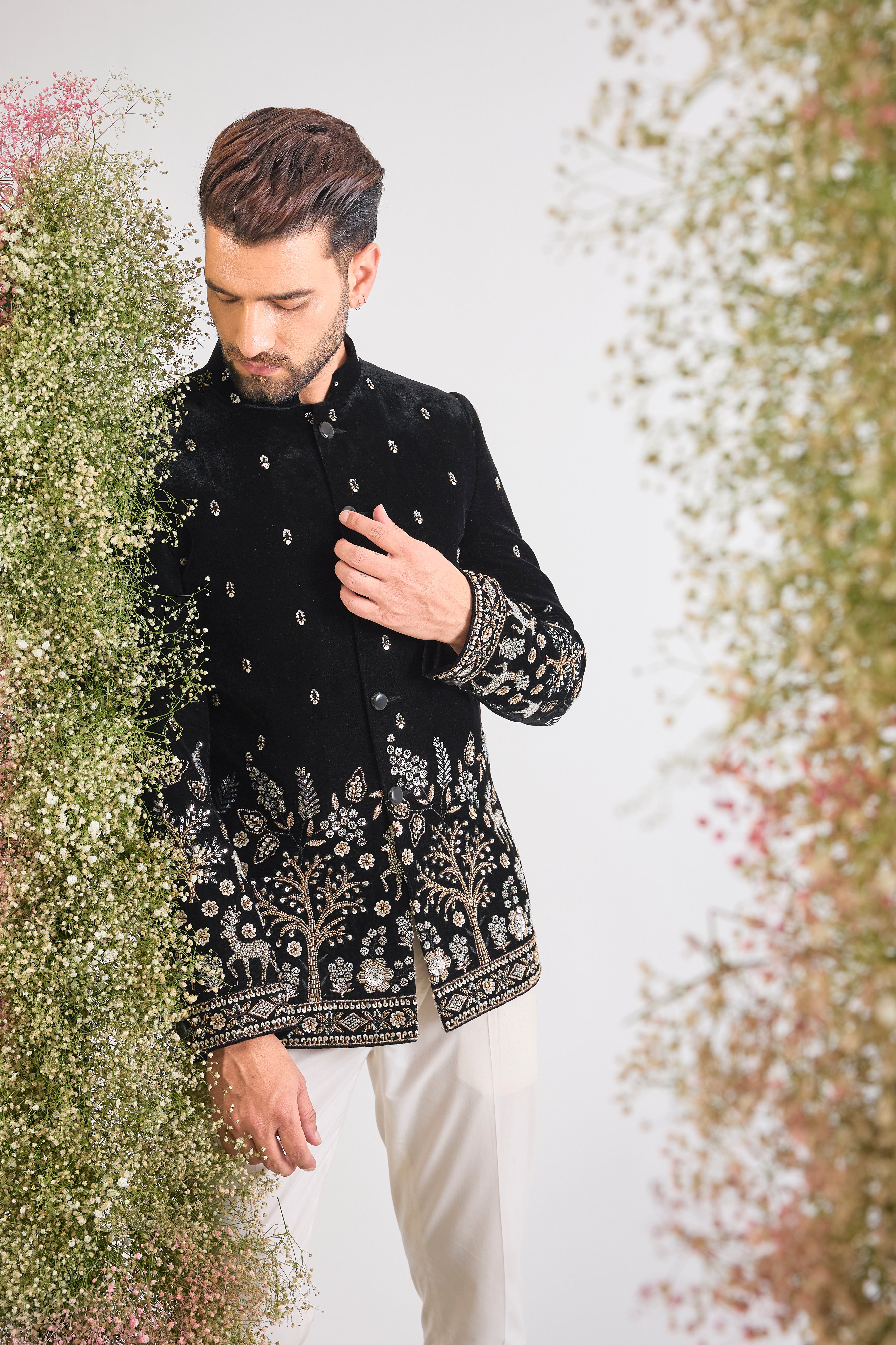 This Black Bandhgala showcases extraordinary, concentrated Handwork featuring shimmering Sequins, textural Beads, and reflective Cut Dana.