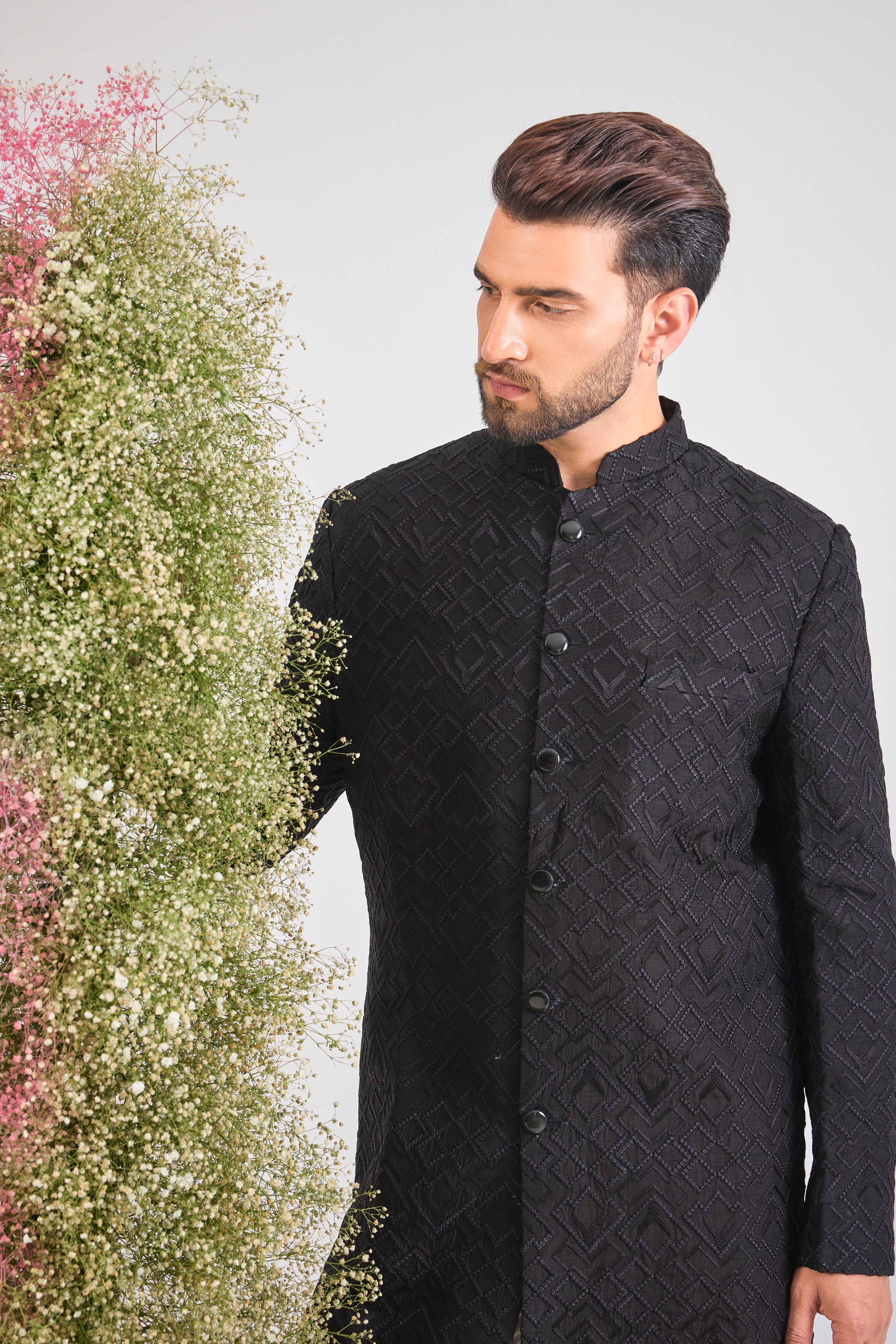 This Sherwani showcases a striking Geometrical Design through Tone-to-Tone Heavy Thread Work, offering unmatched richness and texture.