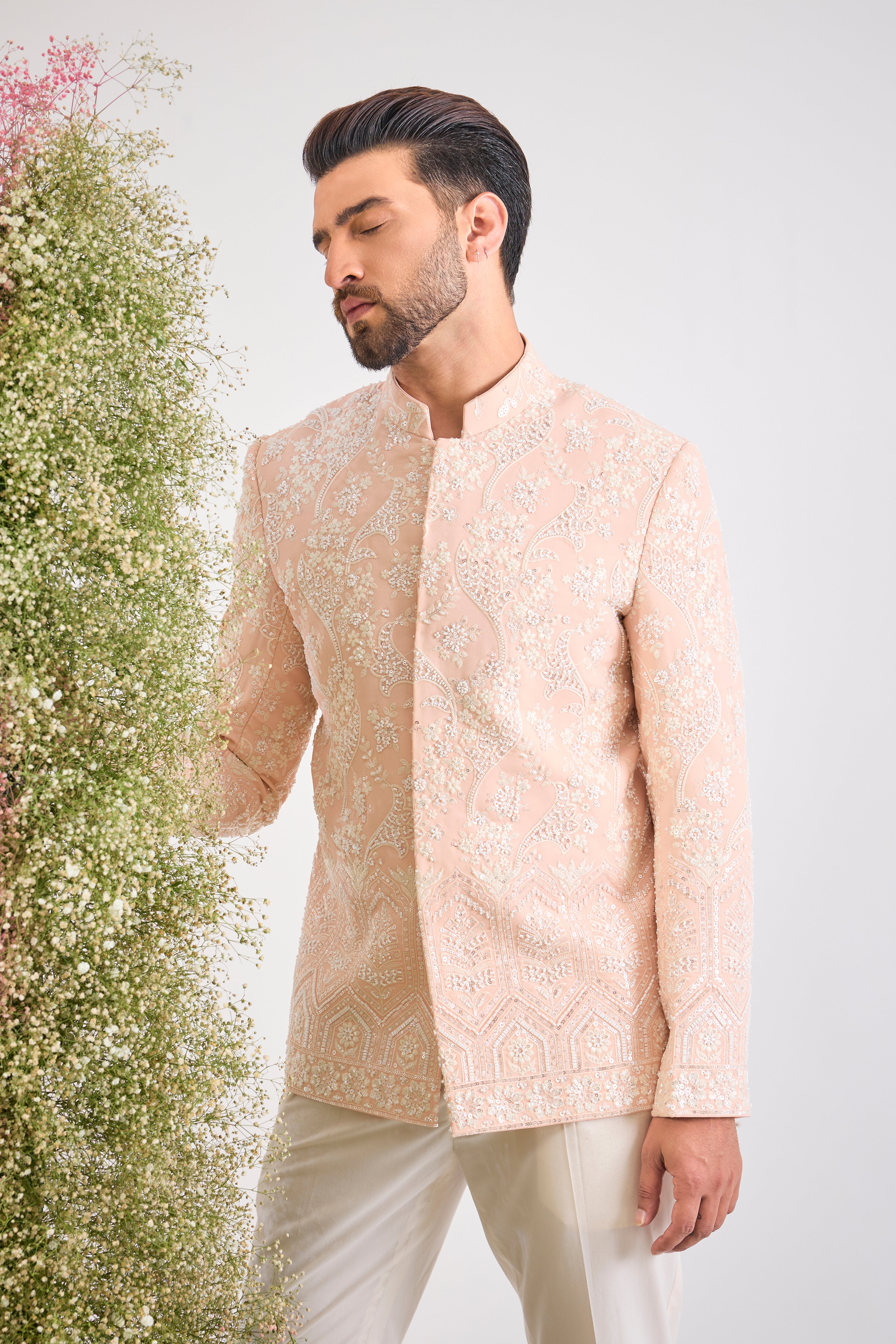This Hand Embroidered Bandhgala features rich, textural detail where Intricate Floral Embroidery is lavishly decorated with brilliant White Cut Dana and Sequins.