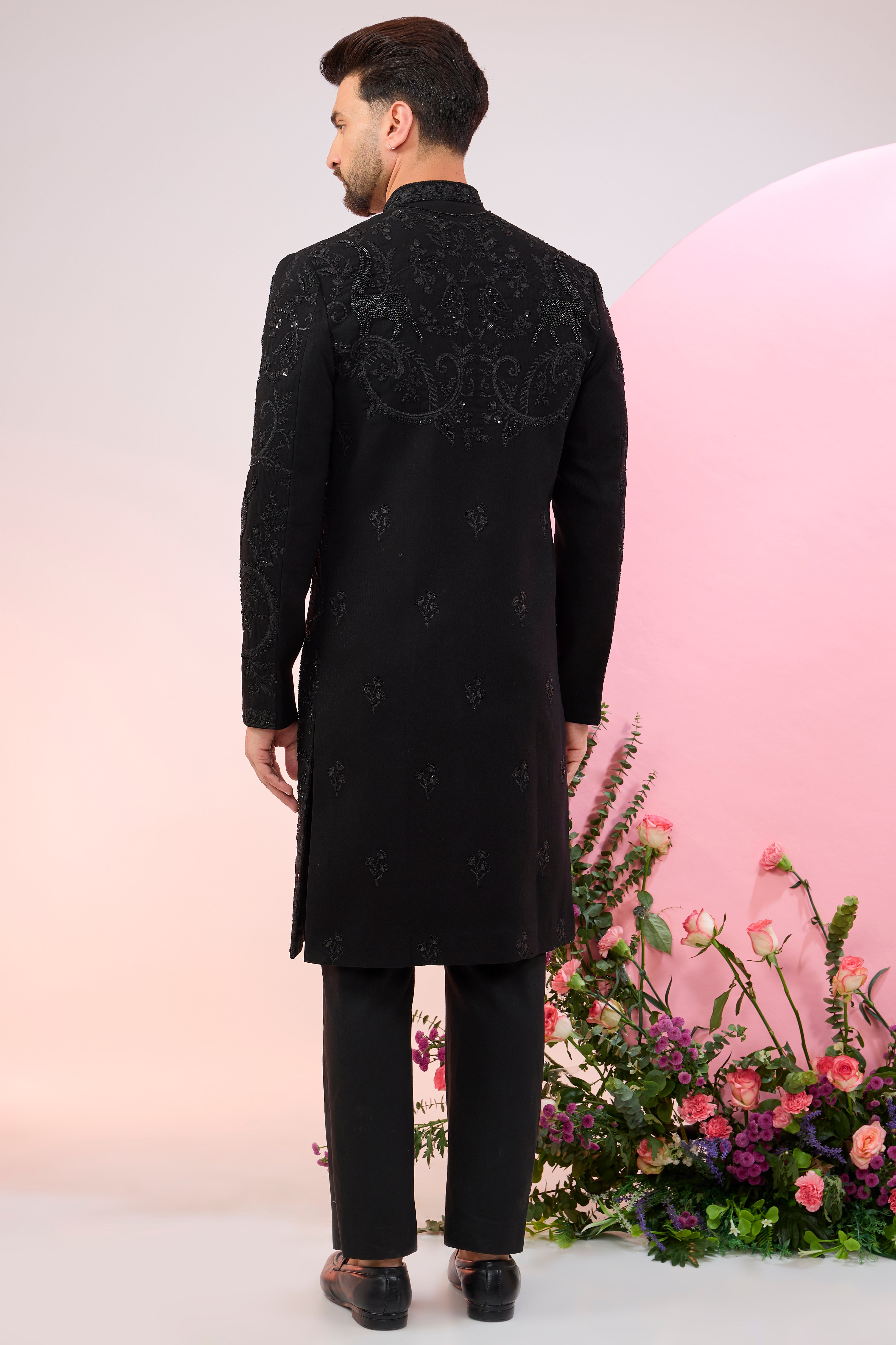 Black hand embroidered cut dana sherwani with flora and fauna motifs.