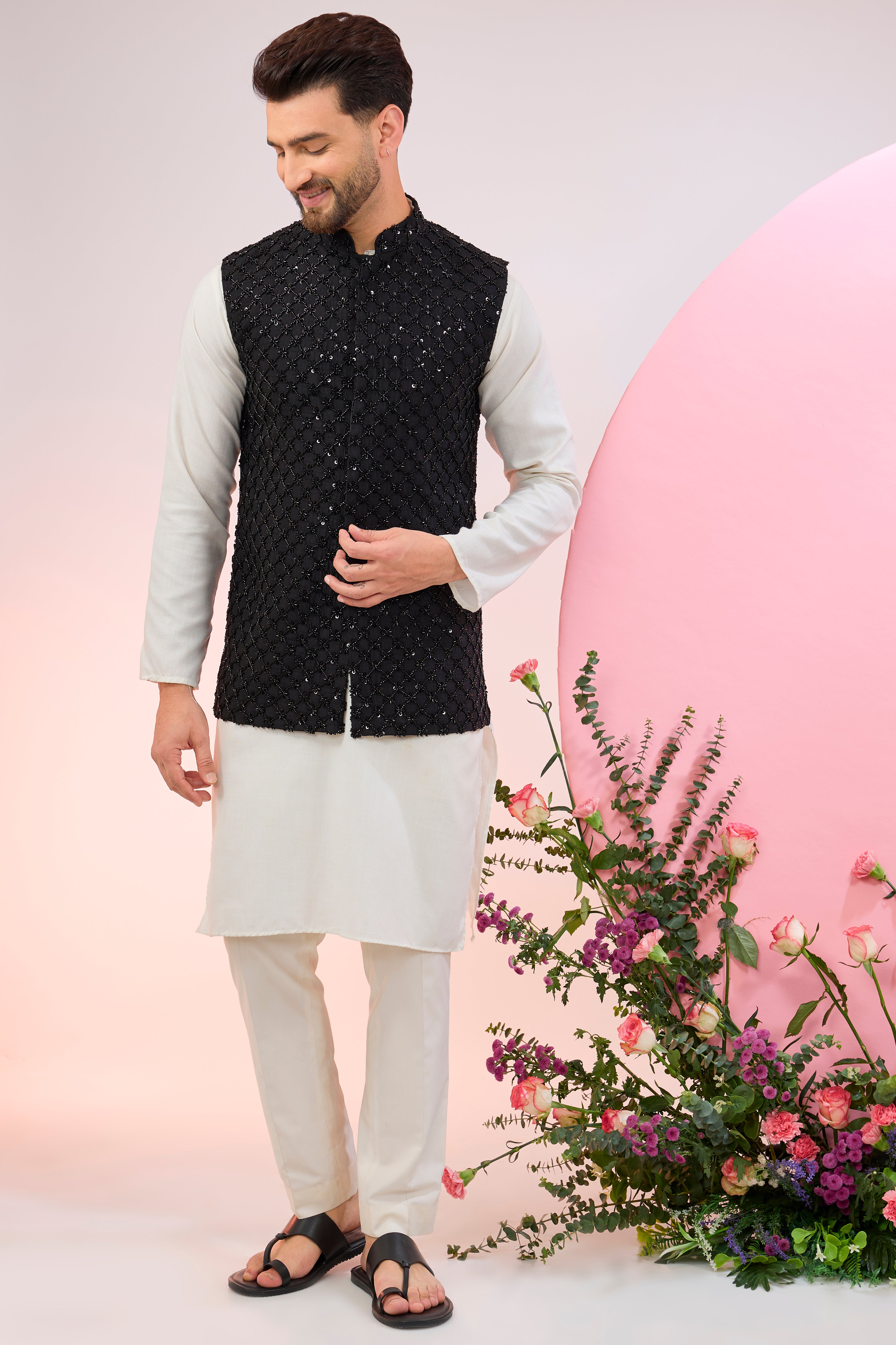 Black nehru jacket with heavy cut-dana embroidery.