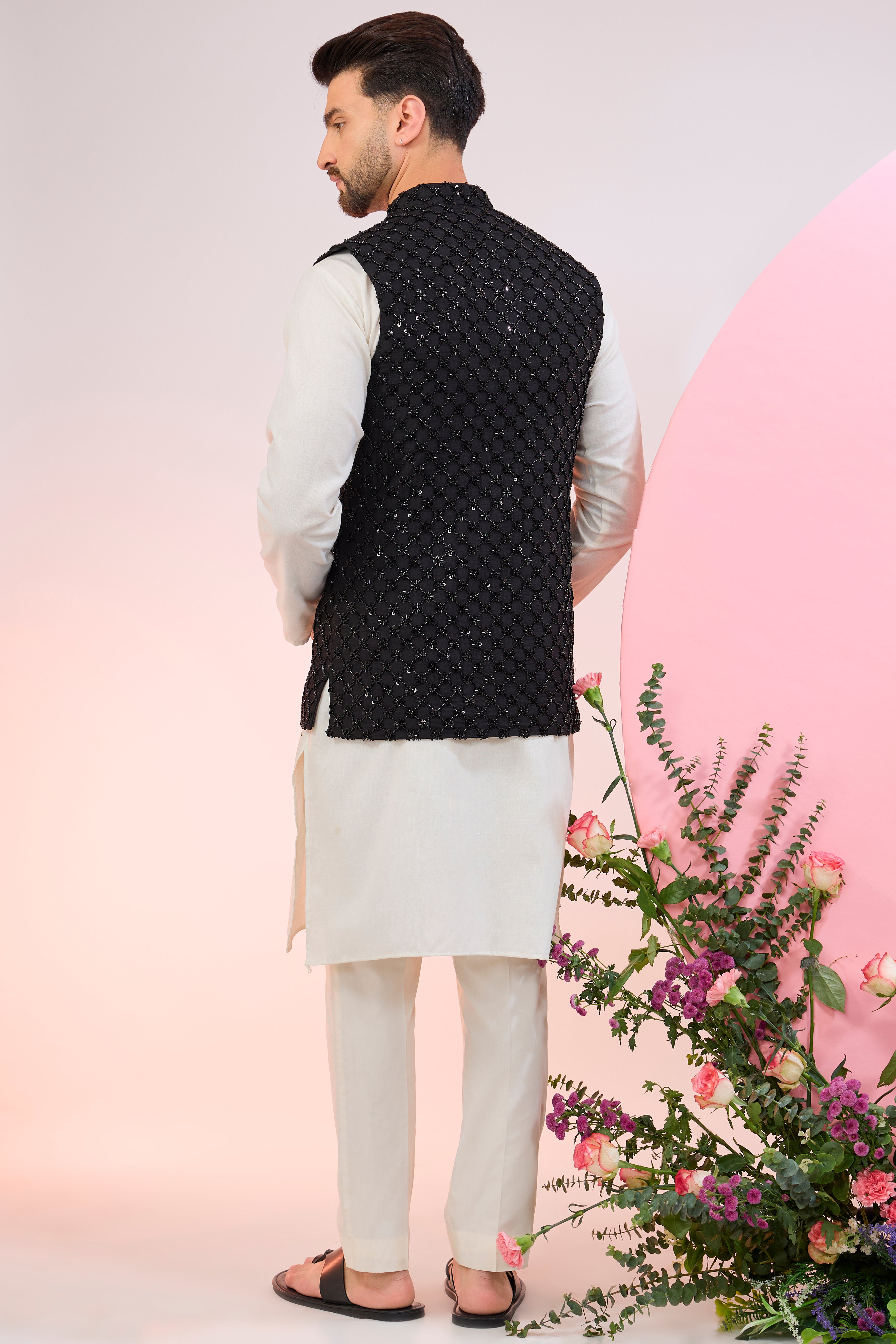 Black nehru jacket with heavy cut-dana embroidery.