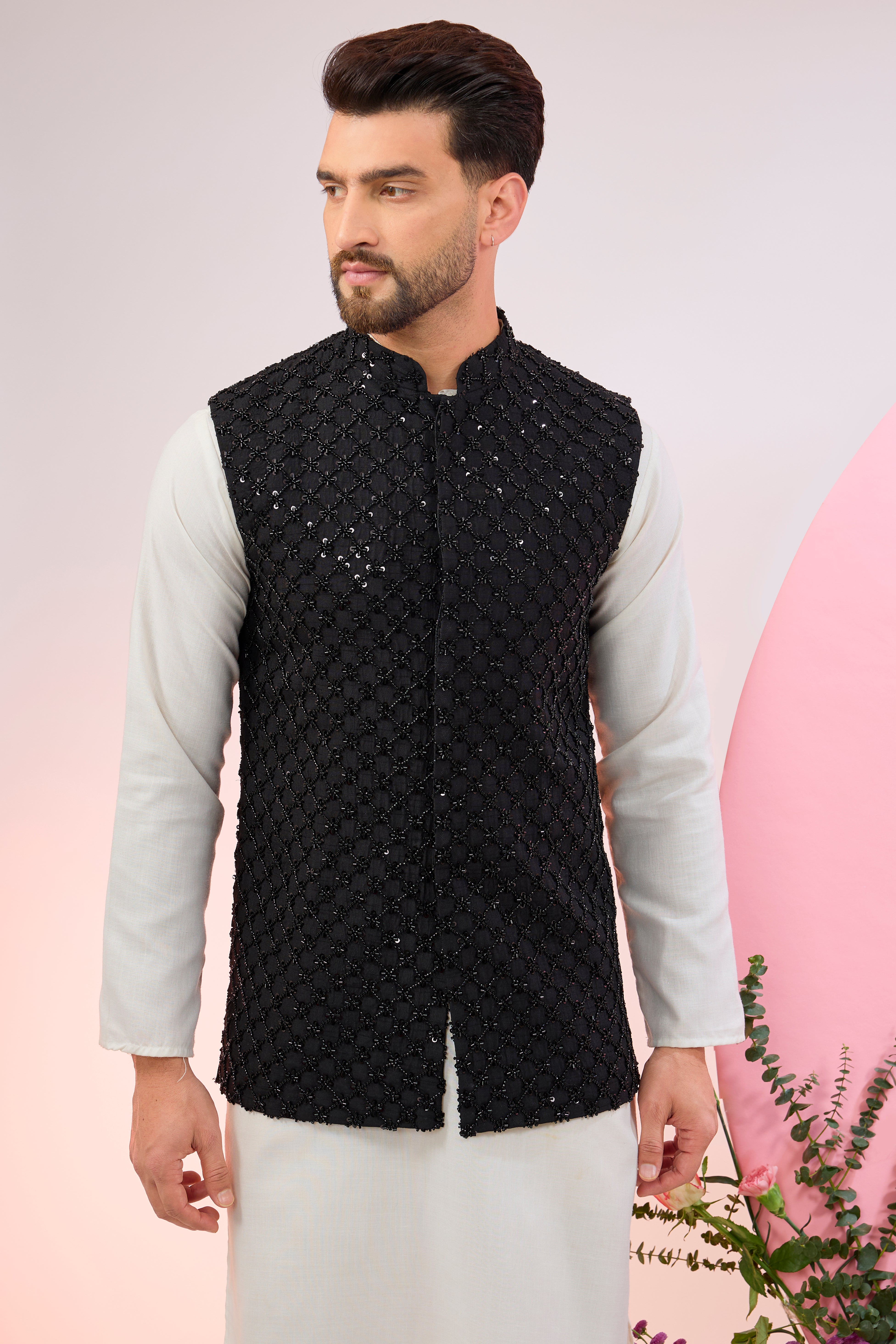 Black nehru jacket with heavy cut-dana embroidery.