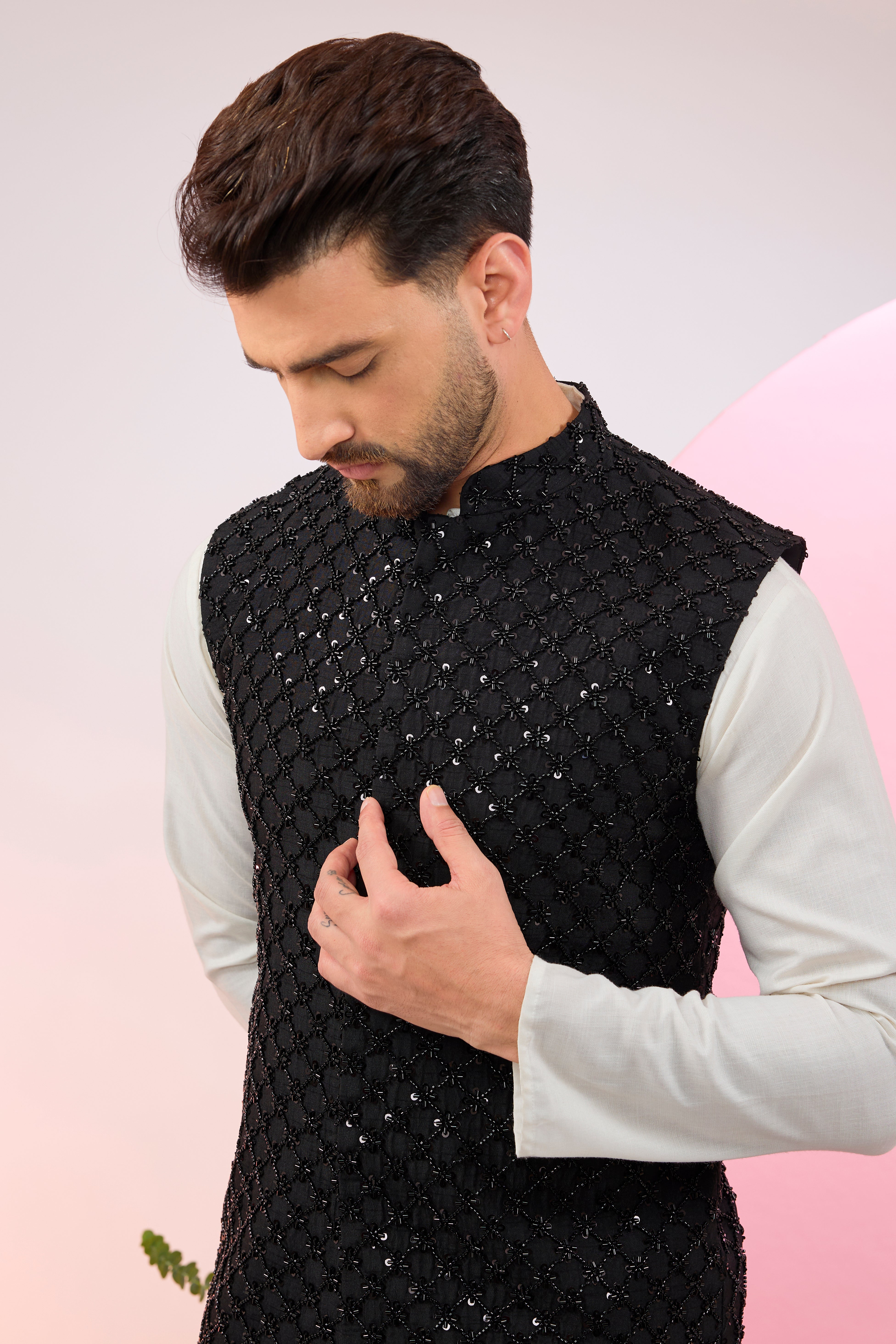 Black nehru jacket with heavy cut-dana embroidery.