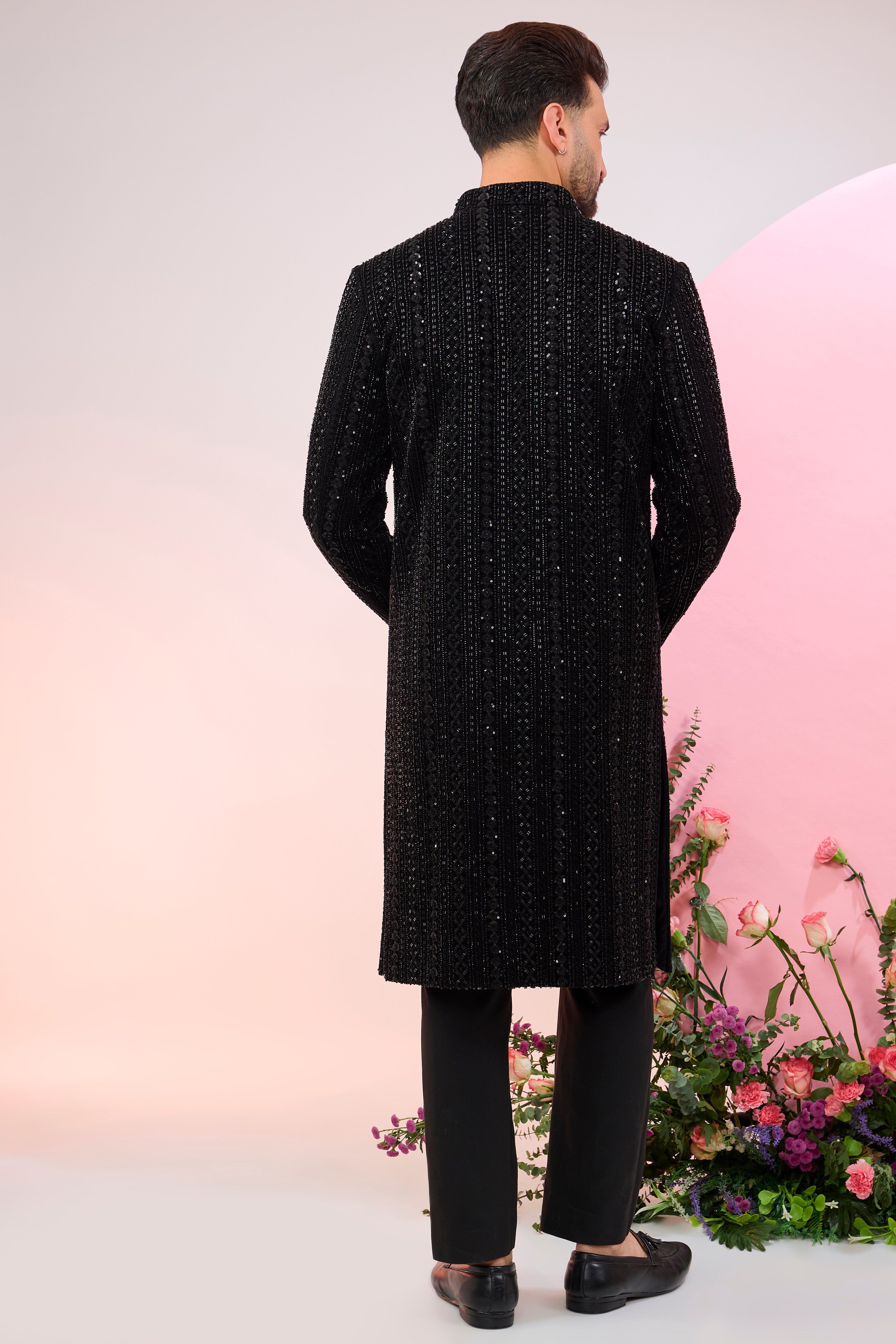 Black sherwani with heavy cut-dana embroidery.