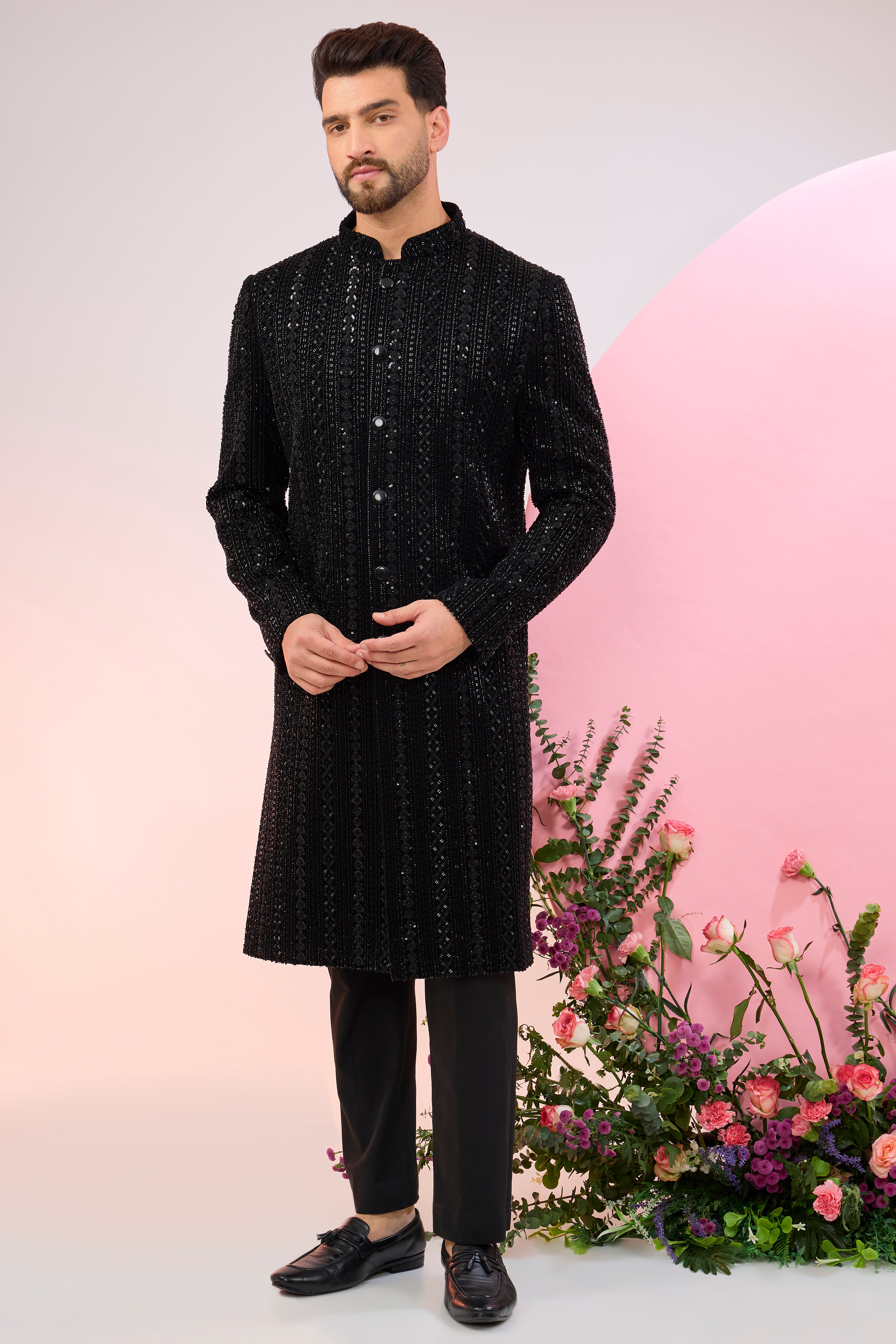 Black sherwani with heavy cut-dana embroidery.