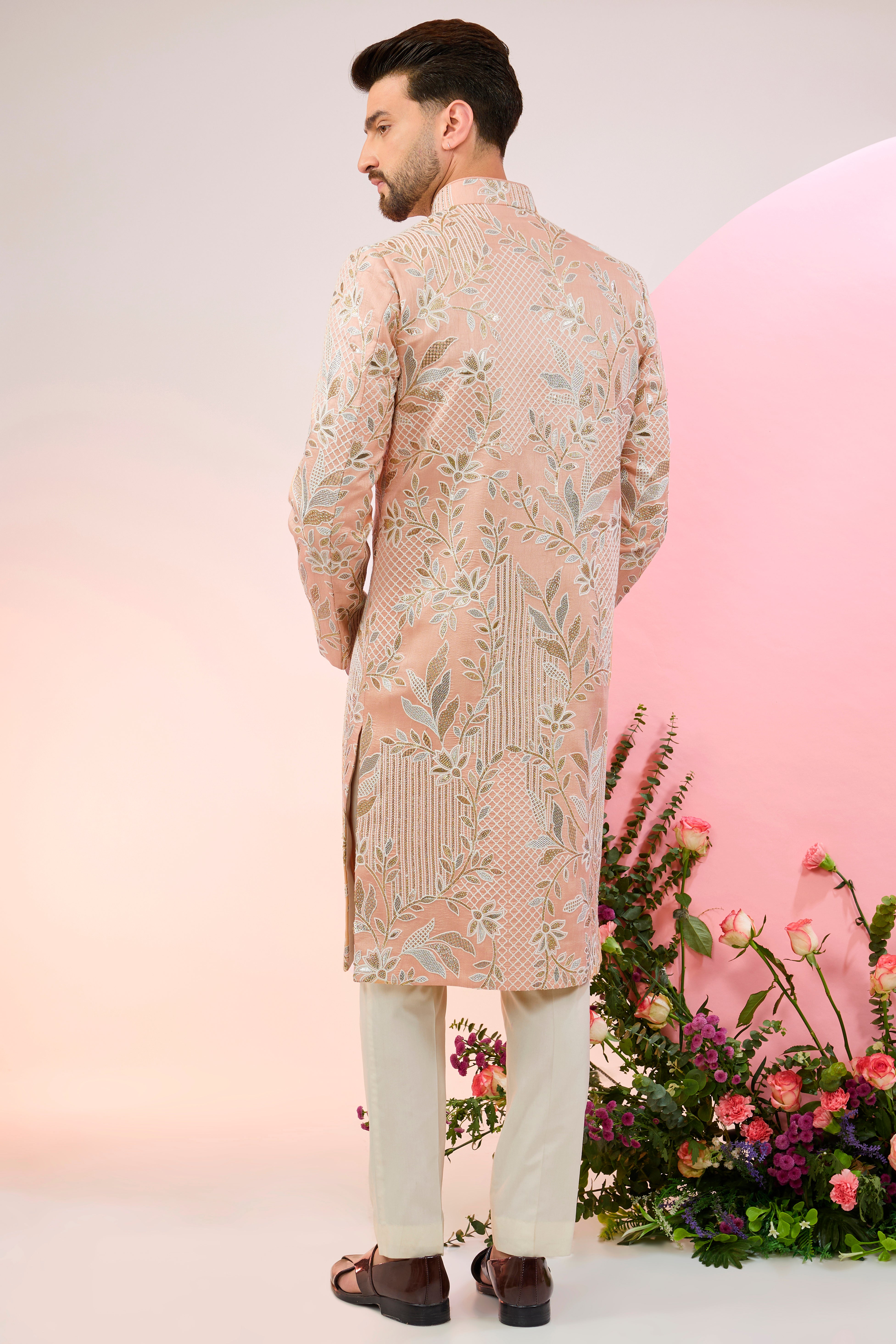 peach sherwani with intricate floral embroidery and subtle sequin work