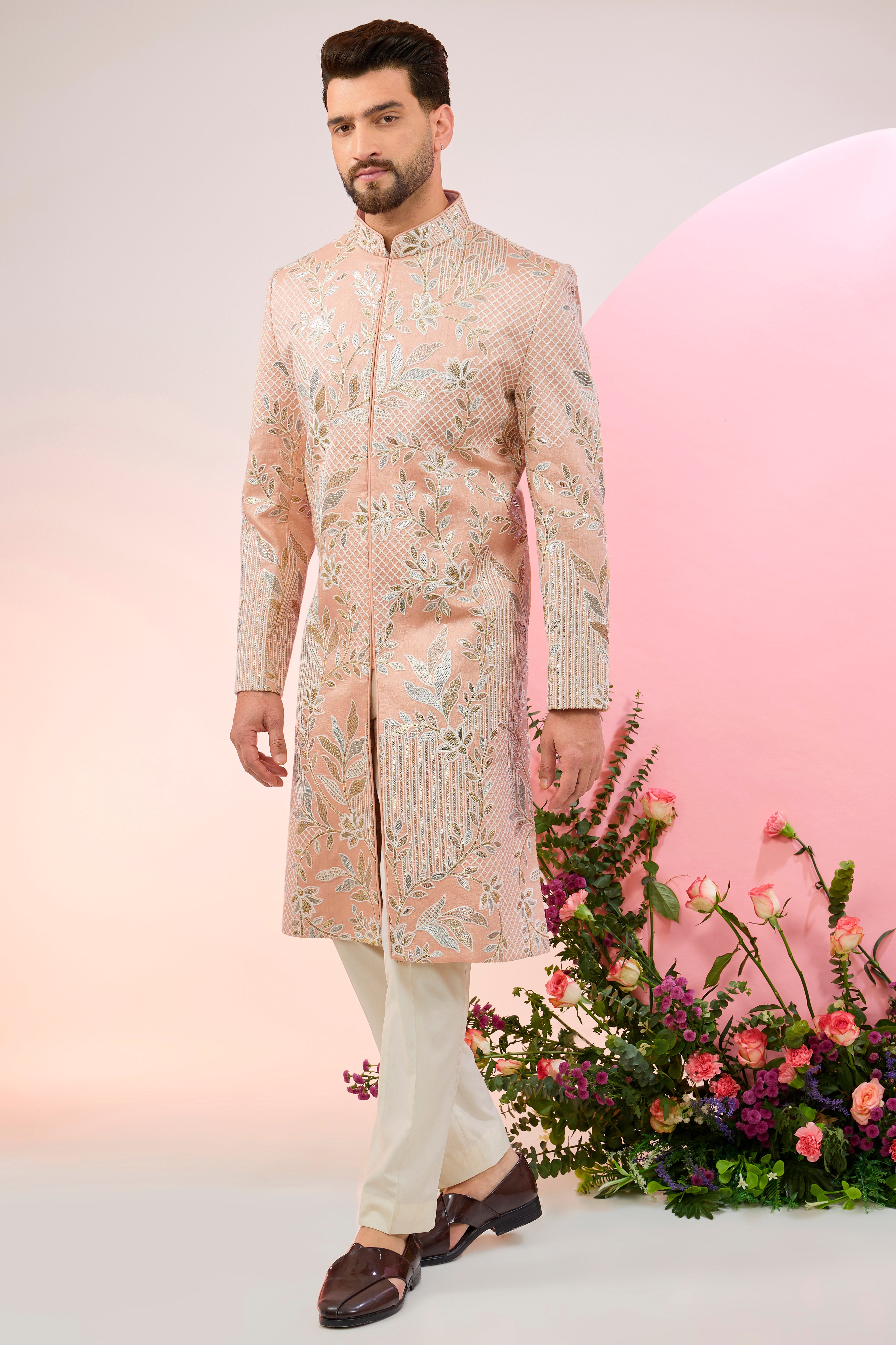 peach sherwani with intricate floral embroidery and subtle sequin work